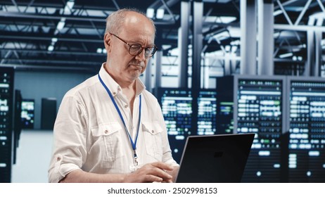 Adept repairman expertly managing data while navigating in industrial server room. Skillful employee ensuring optimal cybersecurity protection, optimizing systems and performing necessary updates - Powered by Shutterstock