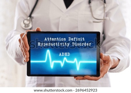 ADHD concept. Attention deficit hyperactivity disorder. Female doctor with words written on a digital tablet