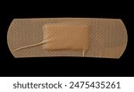 Adhesive band aid crumpled isolated on black background, top view