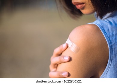 Adhesive Bandage On A Female Arm After Vaccination