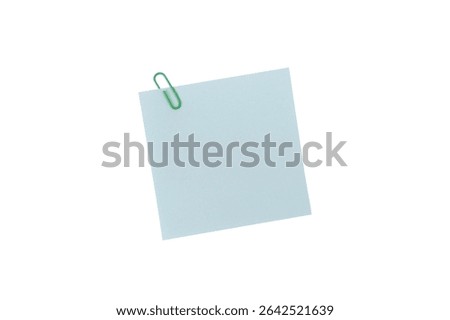 Adhesive notes or sticky note, A single green paperclip secures a blank light blue square note, isolated on a white background include clipping path
