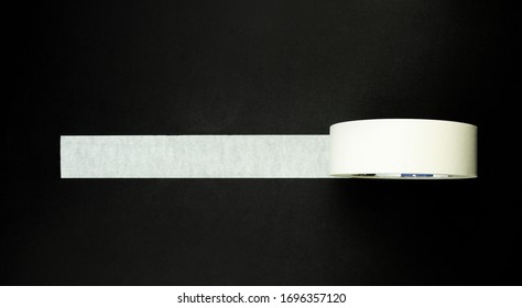 Adhesive Tape On A Black Background. View From Above