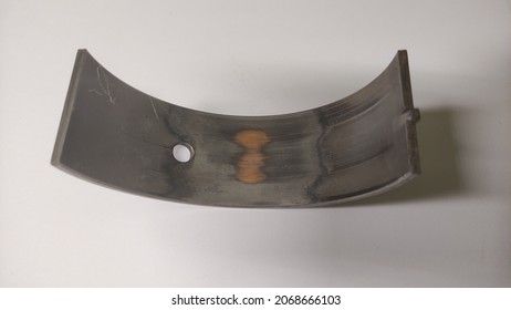 Adhesive wear on main bearing connecting rod engine diesel dump truck heavy equipment. a yellow-brown copper layer is seen. - Powered by Shutterstock