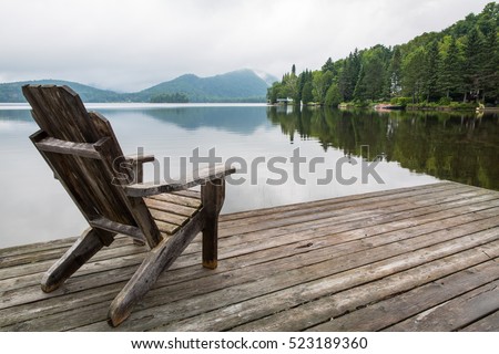 Adirondack chair on lake dock