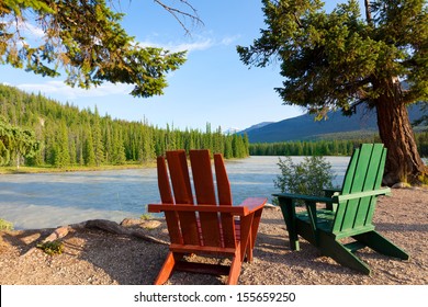 Adirondack Chairs By The Beautiful River In Jasper National Park, Alberta, Canada