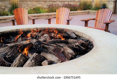 Adirondack chairs by the fire pit - Powered by Shutterstock