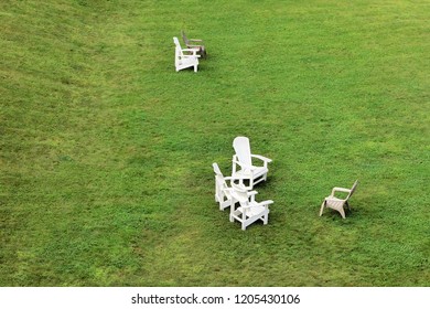 Adirondack Chairs On A Large Green Lawn