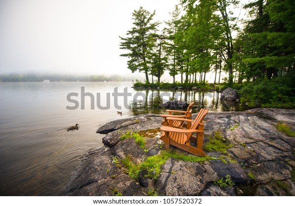 Adirondack Chairs On Rock Formation Facing Stock Photo Edit