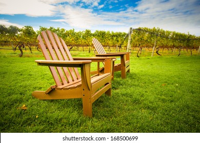 Adirondack style chair on lawn of vineyard