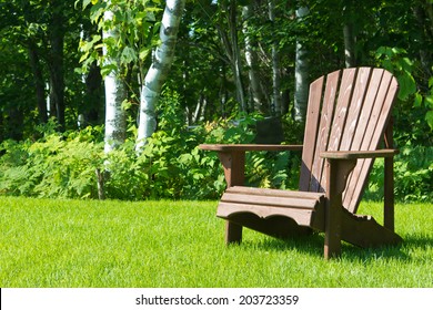 Adirondack Summer Lawn Chair Outside On The Green Grass