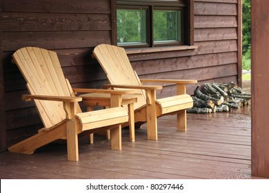 Adirondack Wood Chairs On A Cabin Porch