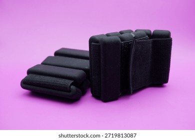 Adjustable Ankle Weights Isolated on Purple Background