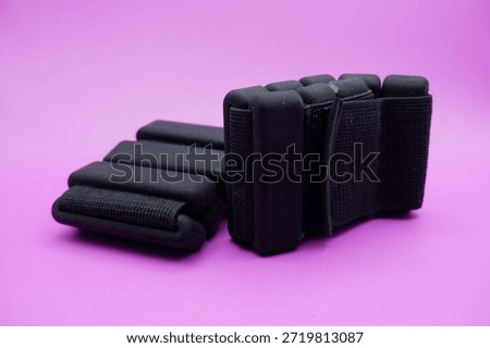 Adjustable Ankle Weights Isolated on Purple Background