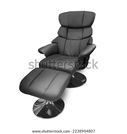 Adjustable black leather chair with footrest isolated on white background. With clipping path