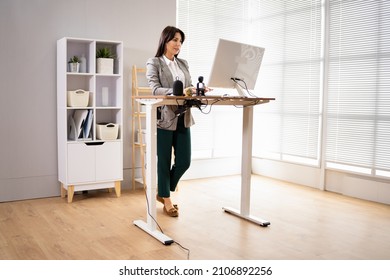 Adjustable Height Desk Stand In Office Using Computer