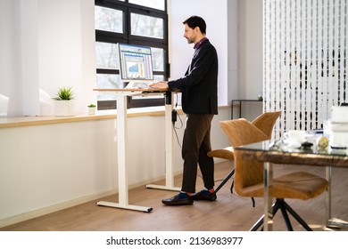 Adjustable Height Desk Stand In Office Using Computer - Shutterstock ID 2136983977