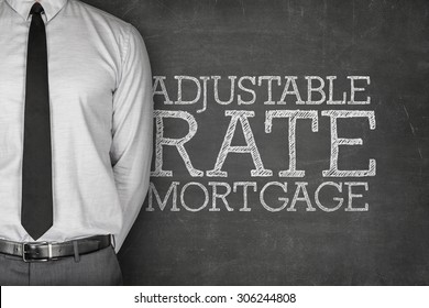 Adjustable Rate Mortgage Text On Blackboard With Businessman On Side