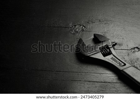 adjustable spanner (monkey spanner). Repair tools. On a black background. Concept of repair or adjustment.