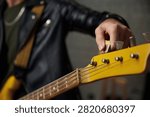 Adjusting headstock before setup. Tuning bass guitar headstock manually