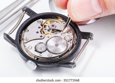 adjusting old mechanic wristwatch - horologist repairs old watch close up - Powered by Shutterstock