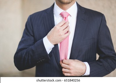 Adjusting Pink Tie