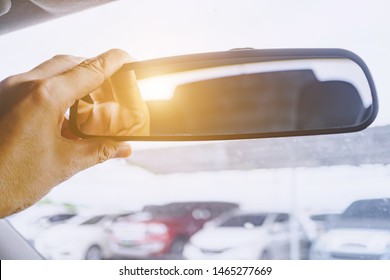 Adjusting the rearview mirror in the car to provide a better rear view for safe use of the car, Rearview mirror adjustment in cars. - Powered by Shutterstock - Get 15% off with code: PIKWIZARD15