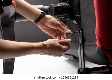 adjusting or repair office armchair. worker fixing arm chair. close up. diy concept.