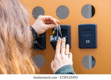 Adjusting security code on apartment key lockbox for self service access in urban short term rental business.