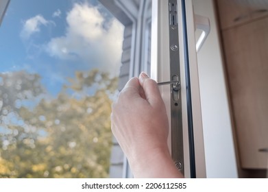 adjusting the white plastic window. a worker uses a hexagon to repair a window. 