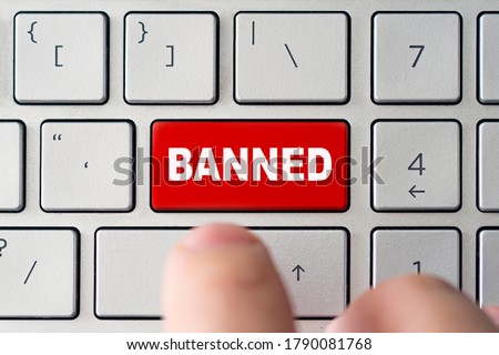 admin bans the user. The red button on the keyboard of a notebook with the inscription of banned. The concept of blocking in the Internet