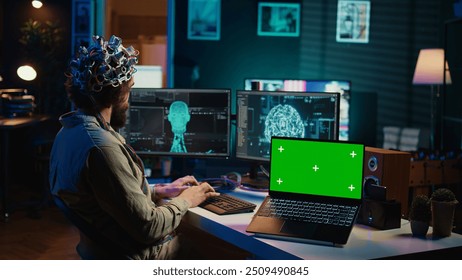 IT admin coding and using EEG headset to upload brain into green screen laptop, gaining immortality. Neuroscientist engineering transhumanism experiment on chroma key device, camera B - Powered by Shutterstock