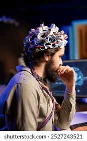 IT admin coding and using EEG headset to upload brain into computer, gaining immortality. Neuroscientist engineering transhumanism experiment, inserting consciousness into cyberspace