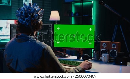 IT admin coding and using EEG headset to upload brain into mockup computer, gaining immortality. Neuroscientist engineering transhumanism experiment on isolated screen PC, camera B