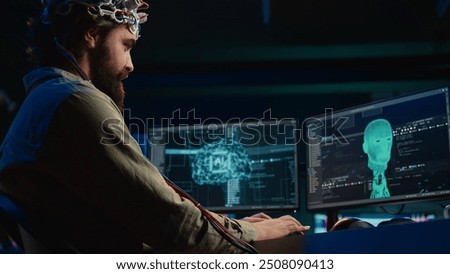 IT admin coding and using EEG headset to upload brain into computer, gaining immortality. Neuroscientist engineering transhumanism experiment, inserting consciousness into cyberspace, camera B