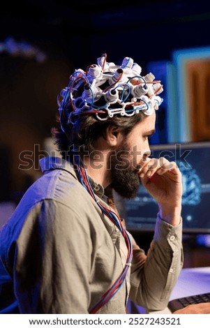 IT admin coding and using EEG headset to upload brain into computer, gaining immortality. Neuroscientist engineering transhumanism experiment, inserting consciousness into cyberspace