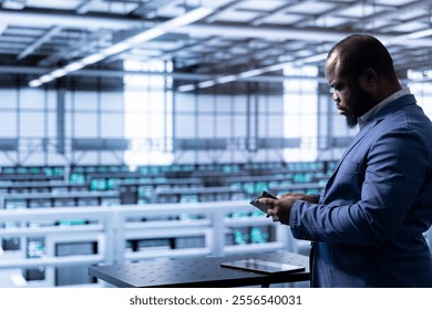 Admin in data center checking storage units and infrastructure components, doing maintenance. Employee looking closely at hard drive, planning and executing server hub migrations and upgrades