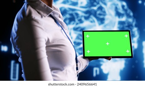 Admin in data center with chroma key tablet using artificial intelligence computing simulating human brain thought processes. African american expert working with AI neural network algorithms