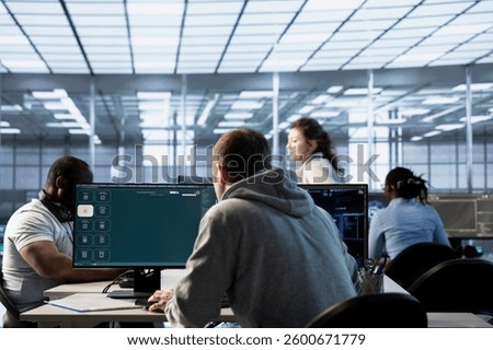 Admin in data center coding AI LLM chatbot software of virtual assistant answering user prompts using predictive technology. Worker building large language model program using artificial intelligence