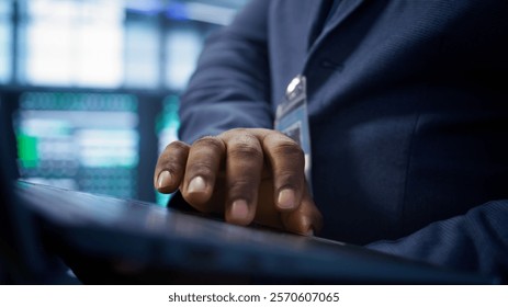 Admin in data center runs system diagnostic tests and error checking utilities on laptop to fix problems. Close up shot of worker looking for network issues affecting rigs performance, camera B