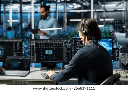 Admin in data center speaks in headset mic, troubleshooting rigs connectivity issues using AI. IT expert doing tech support in server hub, talking in remote call, auditing systems for vulnerabilities