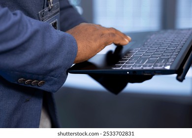Admin in data center uses tools on notebook designed to handle challenges of managing cloud and distributed infrastructure. Close up of worker planning and executing server hub migrations and upgrades