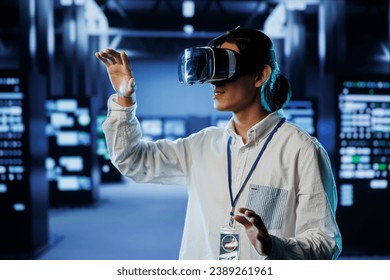 Admin in data center uses virtual reality to prevent system overload during peak traffic periods. Man with VR headset in server farm ensuring enough network bandwidth for smooth operations