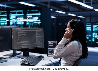 Admin in data center working on PC, providing technical support to customers, troubleshooting issues. High tech server hub worker carrying out operational technical interventions requested by clients - Powered by Shutterstock