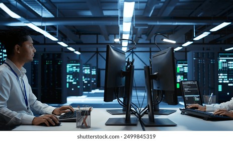 Admin does maintenance on server hub to optimize it for data processing requirements of artificial intelligence workloads. Expert inspects data center used for machine learning, camera B