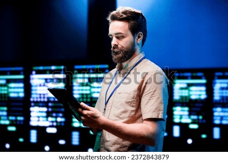 Admin inspecting high tech facility responsible with intense data computations demanding high capacity, scalable, error free network to effectively support AI neural network training