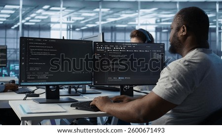 Admin in server hub tasked with protecting valuable data against hacking attack on computers. African american worker safeguarding data center against unauthorized access and vulnerabilities, camera B