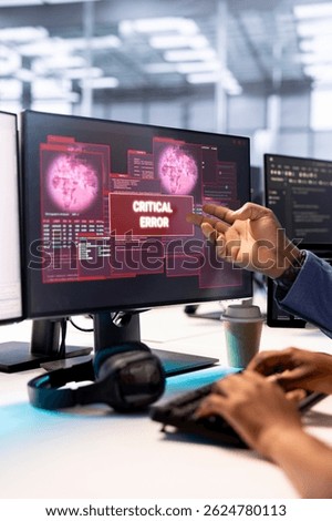 Admin in server hub trying to protect hardware from hacker attack stealing sensitive information. Data center employee struggling to erase virus after seeing security breach alert on monitor