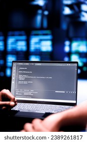 Admin team maintaining and updating server rigs, writing lines of code on laptop terminal, close up. Coders using JavaScript, Java, and database programming to ensure seamless data center computing