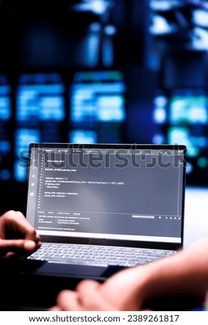 Admin team maintaining and updating server rigs, writing lines of code on laptop terminal, close up. Coders using JavaScript, Java, and database programming to ensure seamless data center computing
