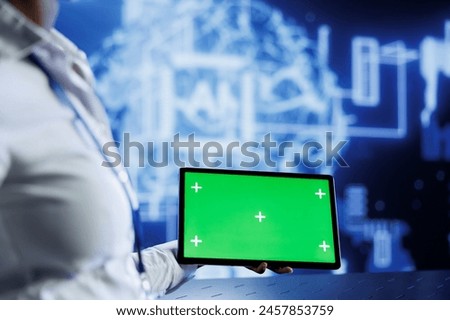 Admin uses green screen tablet to develop artificial intelligence neural networks nodes modeled after human brain. Worker setting up AI machine learning using chrome key device